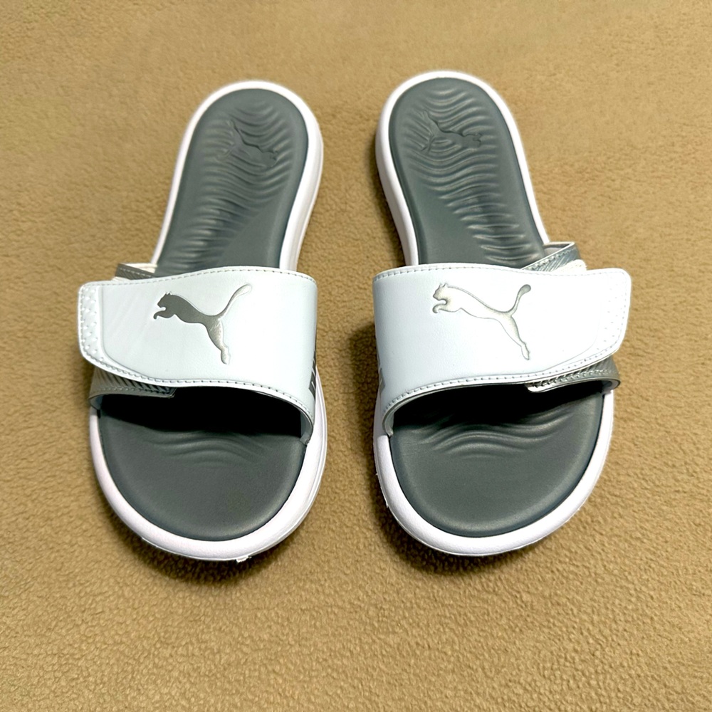 Woman’s white PUMA flip flop